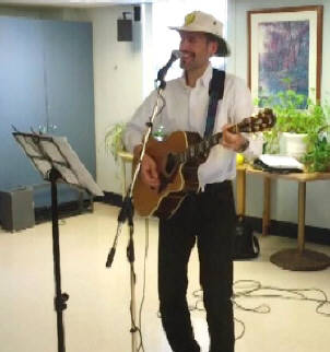 Charles Gregoire playing guitar and singing